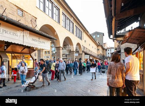 Tourists walking on the famous Ponte Vecchio, a medieval stone arch ...