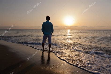 Man alone on beach watching the sunset — Stock Photo © rcaucino #87995742