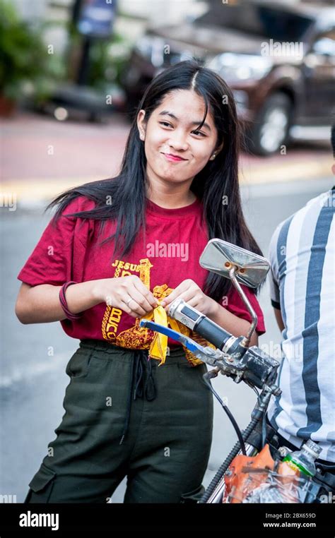 A beautiful filipino girl checks her hair before heading out on the famous annual Black Nazarene ...