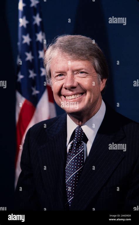 Portrait of President Jimmy Carter in dark suit with US flag in ...