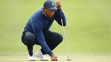 Golfers with bad backs, try switching to a longer putter like Tiger Woods