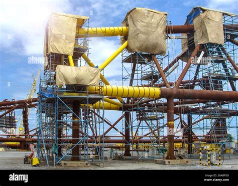 Oil rig platform during construction site in the harbor yard and workers preparing to move into ...