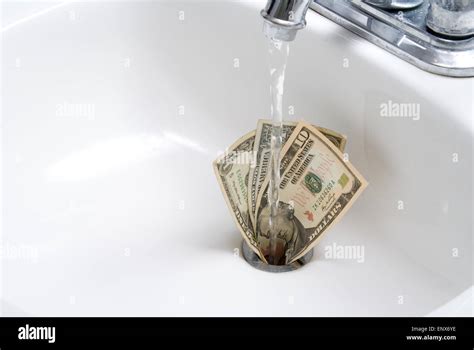 Money Down the Drain Stock Photo - Alamy