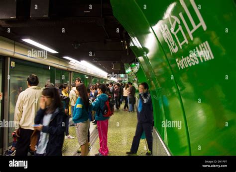 Passengers waiting to board a train at Fortress Hill station on MTR metro subway in Hong Kong ...