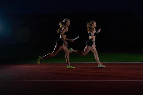 athletic runners passing baton in relay race 12652036 Stock Photo at ...