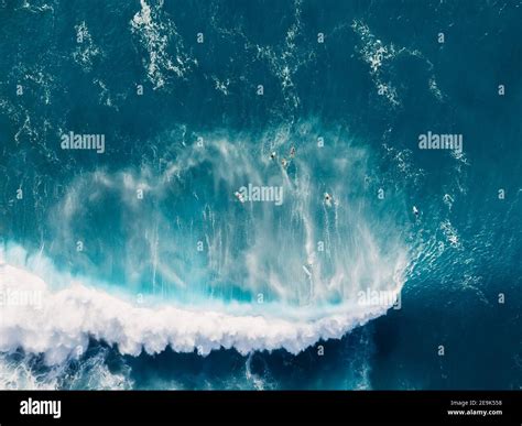 Aerial view of blue ocean with big wave and surfers. Blue waves in ...