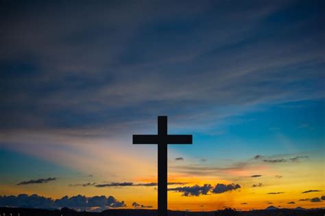 Premium Photo | The cross at the sunset background