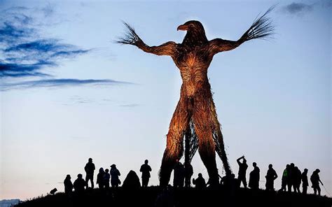 The crowd gathers around a large wooden effigy that will be burnt on the last night of the ...