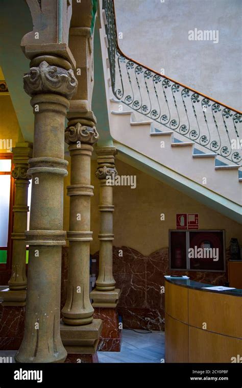 Stone columns in building interior with ornate stairs Stock Photo - Alamy