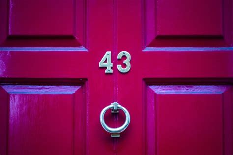 Premium Photo | House number 43 on a red wooden front door in london