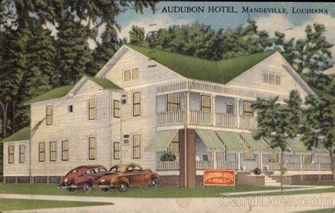 an old postcard with cars parked in front of a hotel