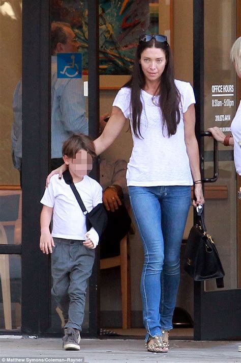 Erica Packer holds on tightly to son Jackson as he wears his arm in a sling | Daily Mail Online