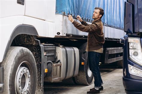 Premium Photo | Truck driver standing by his lorry