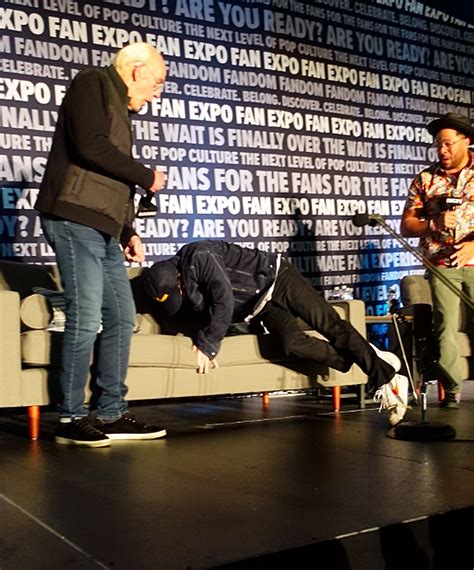 Michael J. Fox falls on stage during 'Back to the Future' panel