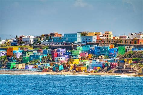 Bright Colorful Houses Line The Hills Overlooking The Beach In San Juan Puerto Rico Stock Photo ...