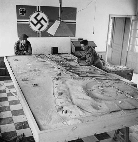 Two Canadian soldiers survey a model of German defenses, C… | Flickr