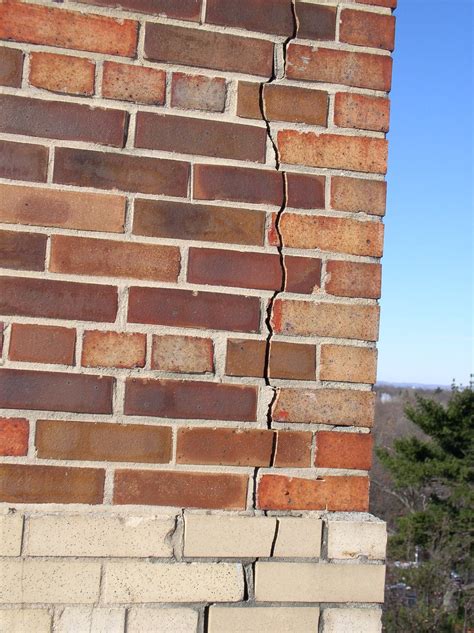 Long, vertical cracks at building corners may indicate underlying structural distress in brick ...