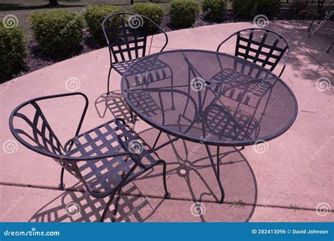 Metal Outdoor Dining Area on Sunny Day with Chairs and Round Table Stock Photo - Image of coffee ...