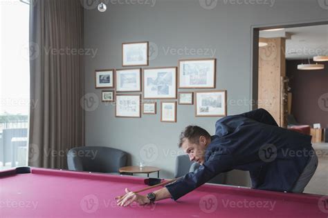 Male tourist taking shot while playing snooker in luxury hotel 22502551 Stock Photo at Vecteezy