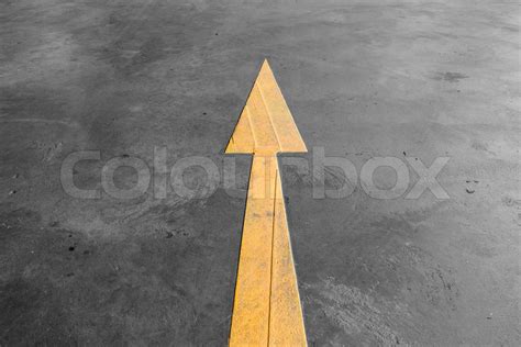 Yellow arrow road sign on the road | Stock image | Colourbox