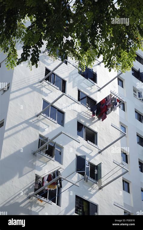 drying laundry hanging from poles at HDB flats in Singapore Stock Photo - Alamy