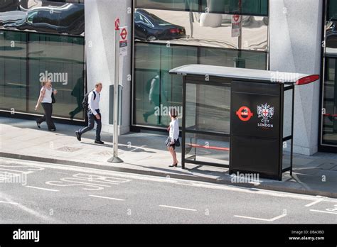 Waiting at city of london bus stop Moorgate. Passenger waits for bus Stock Photo - Alamy