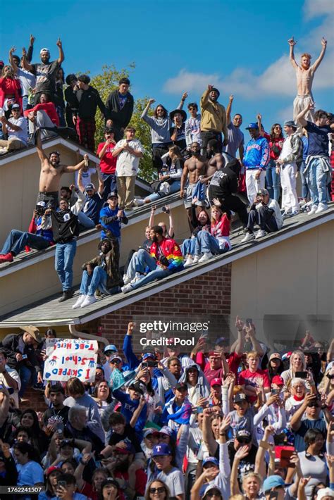 People line rooftops to get a view of passing players during the ...