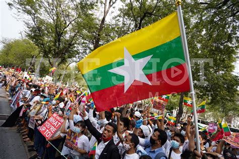 Protester waving the Myanmar big flag - The Shot