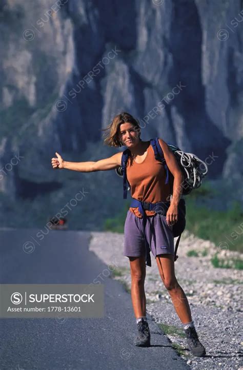 A female climber hitch hiking in El Potrero Chico, Mexico - SuperStock