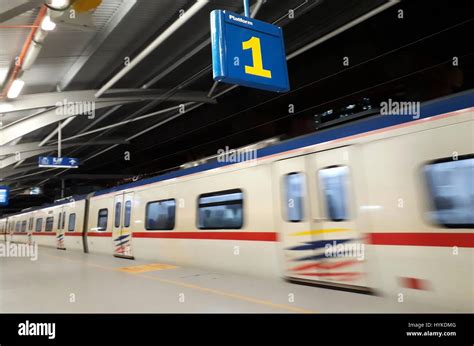 Train arriving at station platform at night Stock Photo - Alamy