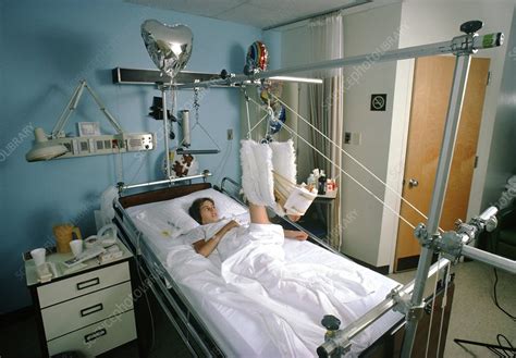 Young woman lying in hospital bed - Stock Image M540/0068 - Science Photo Library