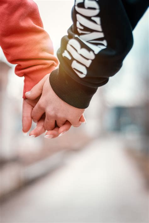 two person holding hands in selective focus photography | Focus photography, Photography ...