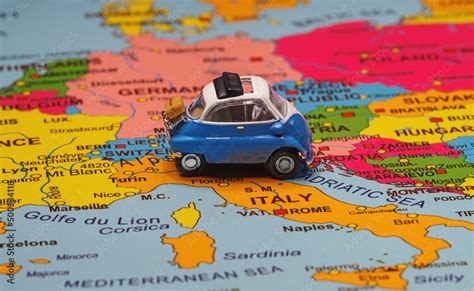 Small toy retro car in the middle of Europe map. Travel by car concept ...