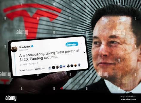 Elon Musk Tesla tweet displayed on mobile with in the background Elon ...