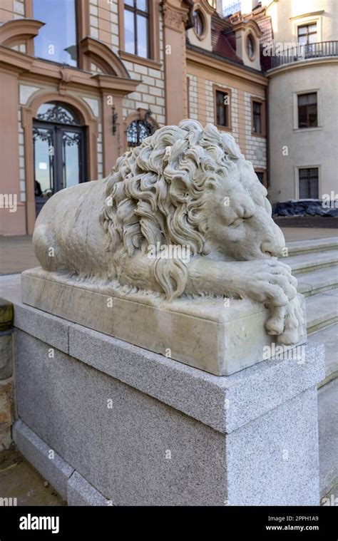 17th century Moszna Castle, statue of sleeping lion in front of ...