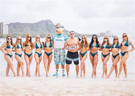 Coastal Carolina head football coach Tim Beck (57) with the school's dance team on beach in ...