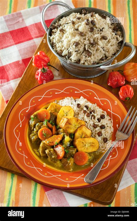 Curry goat with rice and gungo peas. Jamaica Food Stock Photo - Alamy