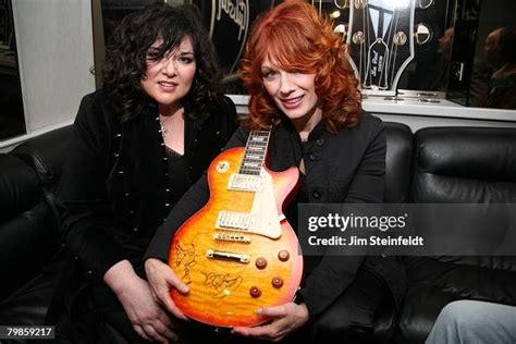 Rock band Heart pose for a portrait in the Gibson tour bus holding an ...