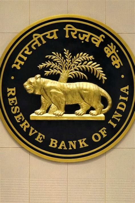 the reserve bank of india logo is shown in gold and black on a white wall