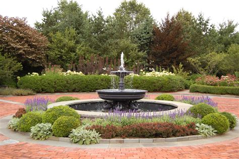 An aluminum & lead fountain in circular driveway in front of house - great choice for a fountain ...