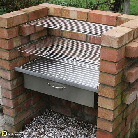 an outdoor bbq grill built into the side of a brick wall with gravel ...