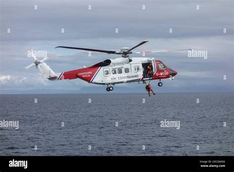 HM Coastguard Helicopter with winch-man Stock Photo - Alamy