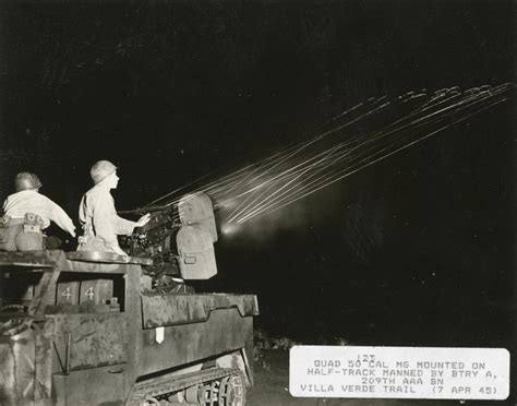 A quad .50 Cal machine gun mounted on a half track is manned by Btry A ...