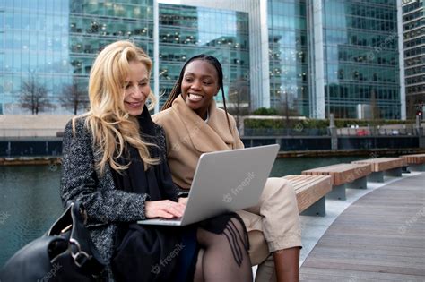 Premium Photo | Businesswomen working outdoors using a laptop