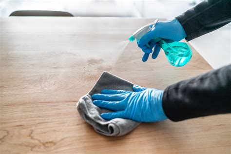 Surface cleaning spraying antibacterial sanitizing liquid with bottle washing table top at home ...