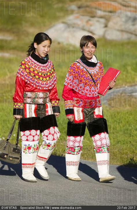 Inuit women wearing traditional Greenlandic national costume or Kalaallisuut in Ilulissat on ...