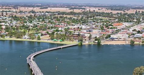 Aerial of the bridge between Mulwala and Yarrawonga and buildings of Yarrawonga and farmland in ...