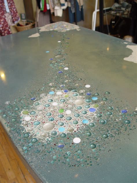 Colorful concrete counter with multiple glass embeds by www.ColoradoConcreteCountertops.com ...