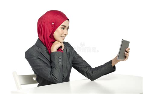 Young Woman with Hijab Sitting with Smile Face, Look at Her Handphone ...