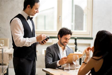 Waiter taking orders in a restaurant Stock Photo | Adobe Stock